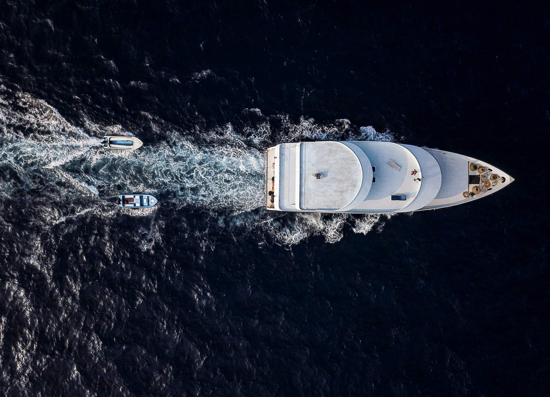 Aerial view of a motor yacht under way on a dark sea